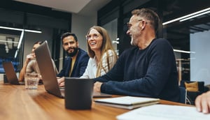 tech-team-at-table-smiling